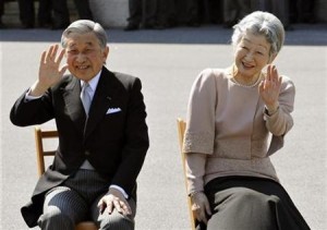 Japan's Emperor Akihito and Empress Michiko wave to well-wishers as they listen to the Imperial Guard music band's performance in the Imperial Palace compound in Tokyo
